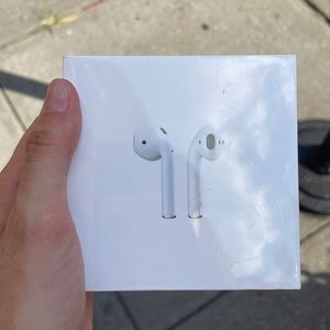 Apple AirPods first generation, brand new and unopened.